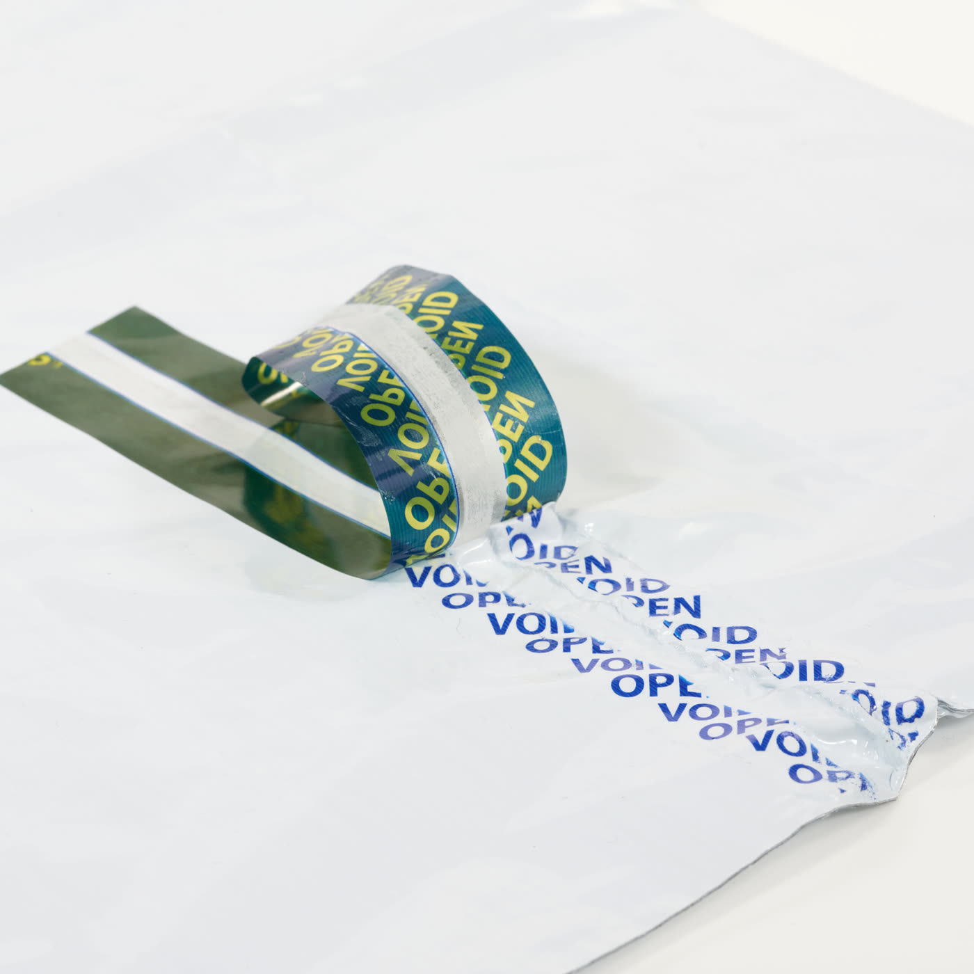 Tamper-evident bag tape showing a two-tone void message after opening